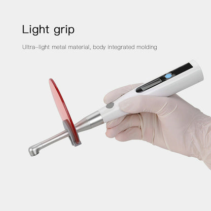 Dentist holding the lightweight cordless curing light, showcasing its 155g portable design.